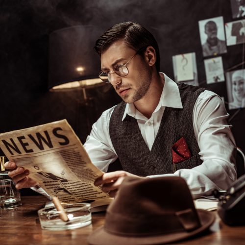 Pandora 2 Concentrated detective in glasses reading newspaper in dark office
